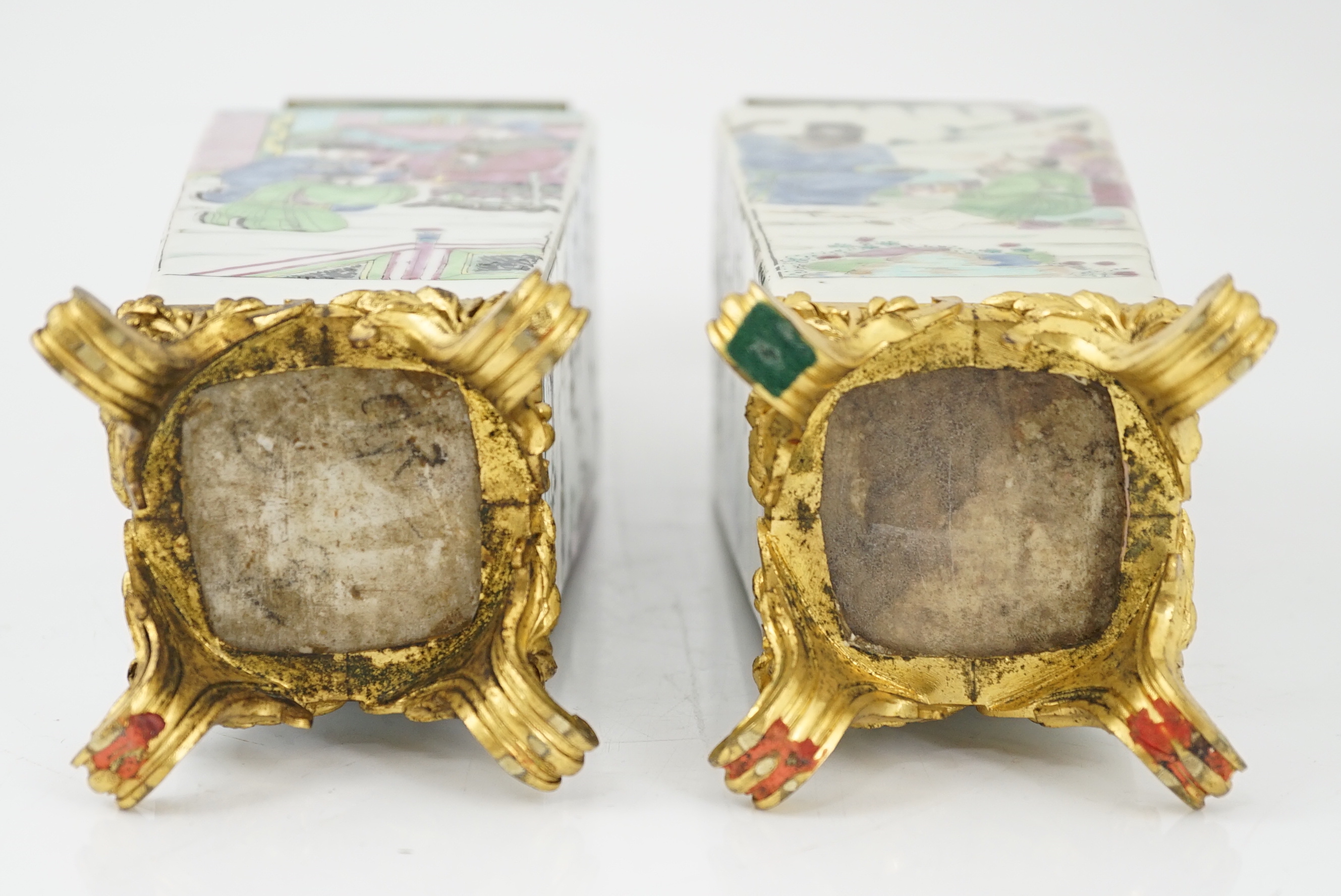 A pair of Chinese famille rose square baluster vases, late 19th/early 20th century, with European gilt metal mounts, each painted with figure scenes, total height 32cm